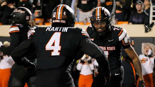 Oklahoma State's Cameron Epps (7) celebrates his interception with Nickolas Martin (4) in the first half of the college football game between the Oklahoma State University Cowboys and the Kansas State Wildcats at Boone Pickens Stadium in Stillwater. Okla., Friday, Oct. 6, 2023.